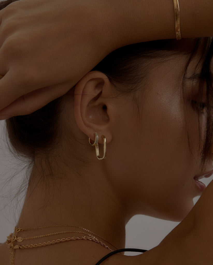 Model wearing gold-filled hoops from Midori Jewelry Co.